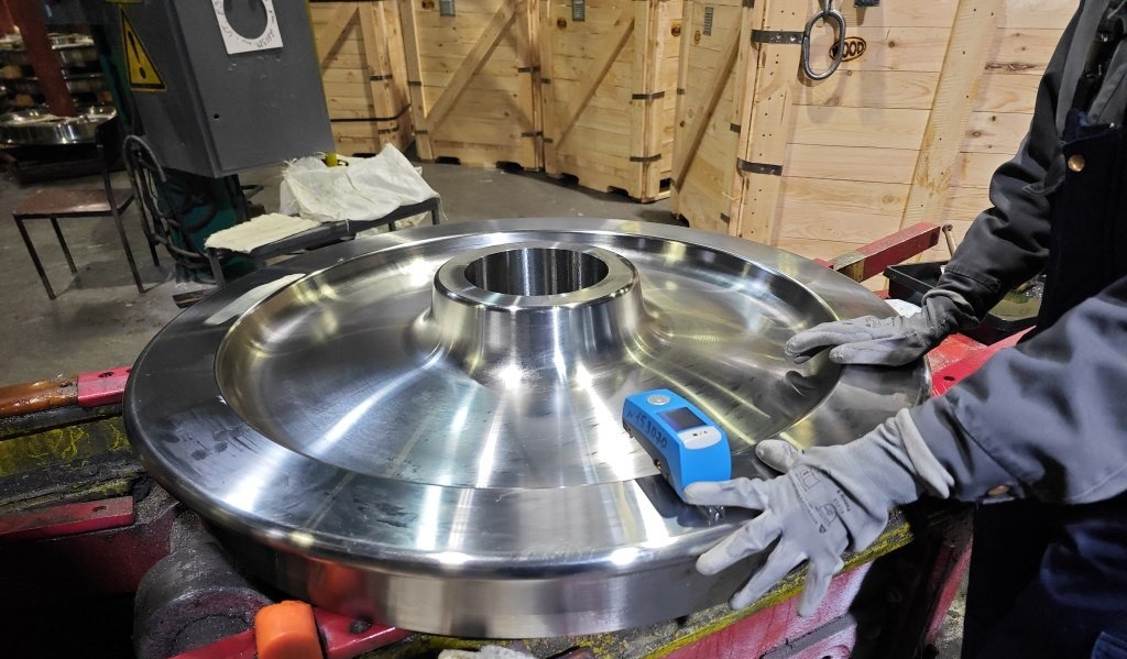 Inspector measuring a steel part