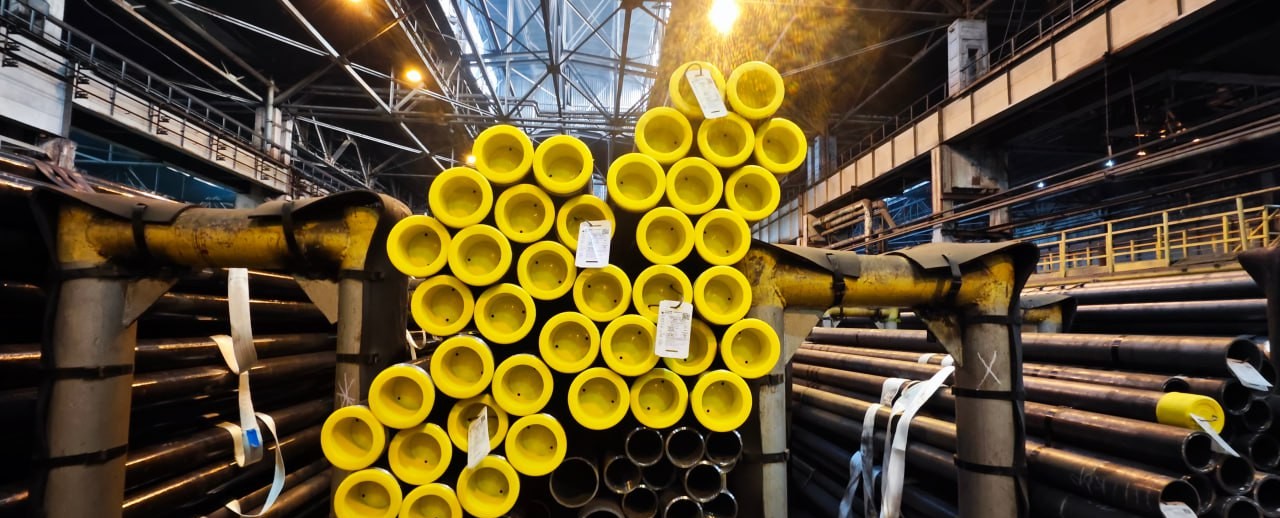 Bright yellow steel pipes awaiting inspection
